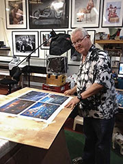 Ron Rinlely looks over a sample before priinting the larger gyclee prints