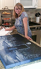 Sheri Hoeger prepares to measure a painting